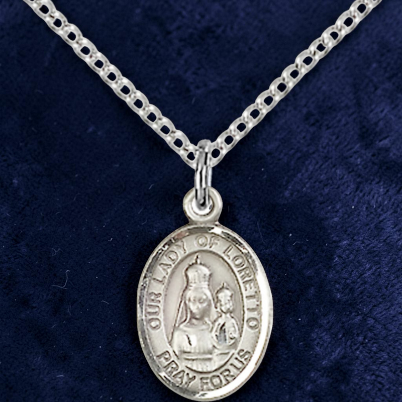 Silver medal necklace with 'Our Lady of Loretto' on a blue background