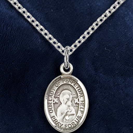 Silver religious pendant necklace on a dark blue background