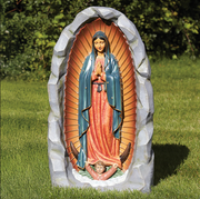 Painted Our Lady of Guadalupe outdoor grotto statue in a backyard setting