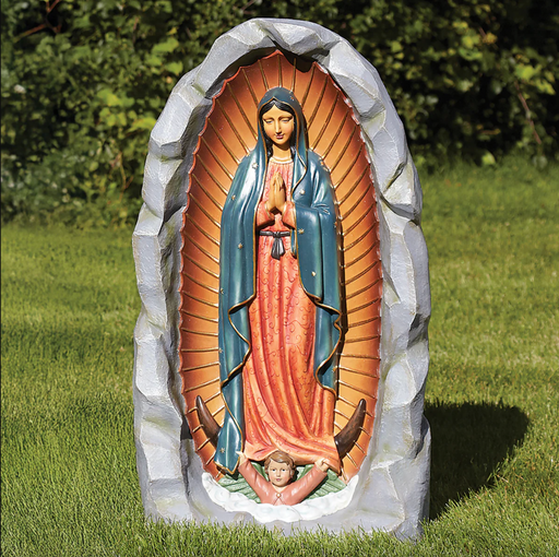 Painted Our Lady of Guadalupe outdoor grotto statue in a backyard setting