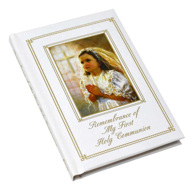 Booklet for First Holy Communion with a young girl holding a cross on the cover