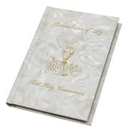 White book with gold text and design, likely for a religious ceremony, on a white background