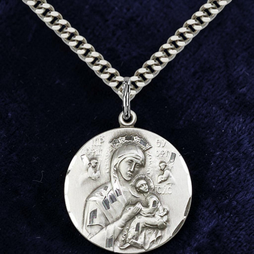 Silver necklace with a pendant featuring an engraved design on a dark blue background