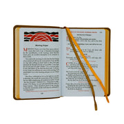 Open book featuring prayer text and an orange ribbon marker.