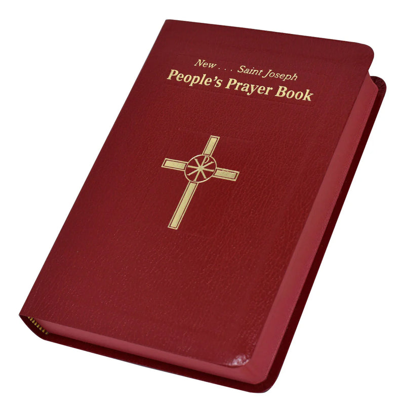 Red prayer book with gold cross and text on a white background