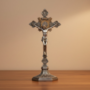 Decorative crucifix on a wooden surface with a beige background