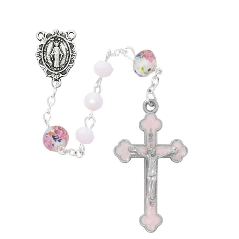 A silver rosary with pink matte and Venetian glass beads, featuring a Miraculous Medal centerpiece and a cross, displayed against a white background.