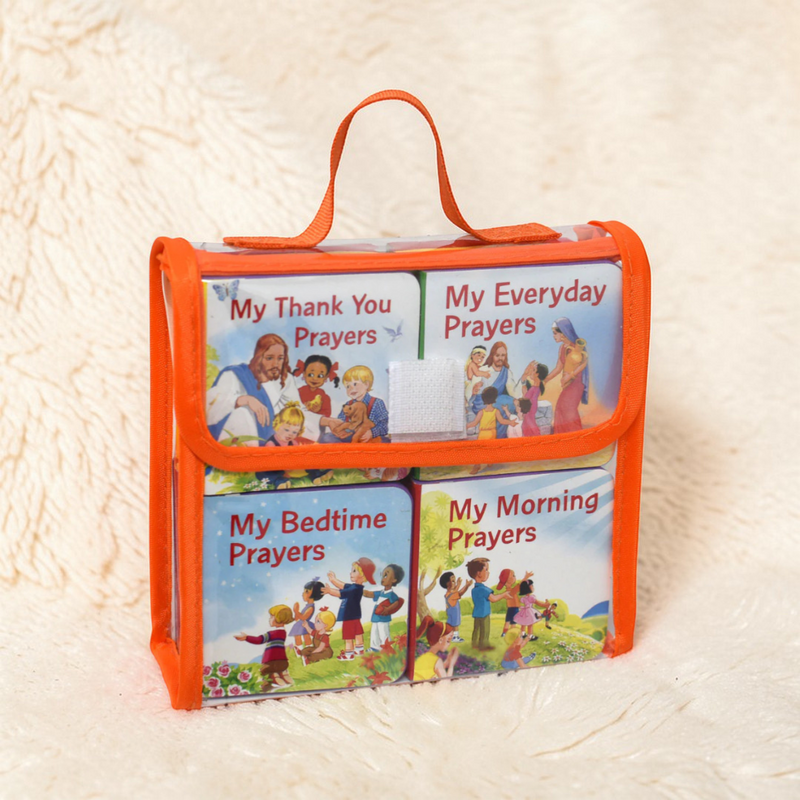 Set of children's prayer books in an orange holder on a beige background