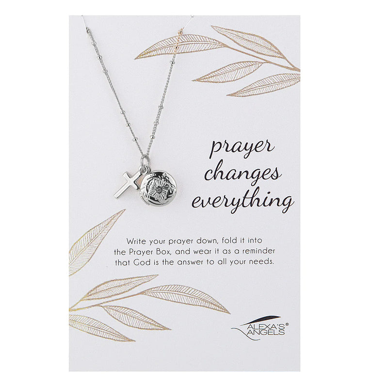 Necklace with prayer box pendant on a card with leaf designs and text.