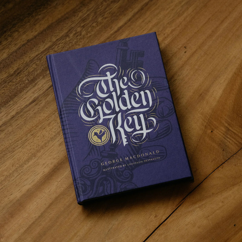 Purple children's book titled 'The Golden Key' on a wood surface.