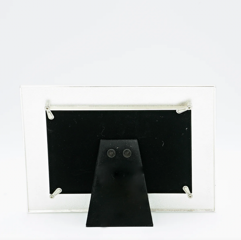 Rear view of a white and silver First Communion picture frame for a 4x6 inch size photo on a white background.