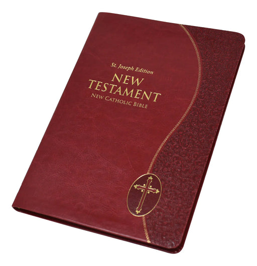 Red leather-bound New Testament with gold cross on a white background