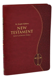 Red leather-bound New Testament with gold text and cross emblem on a white background