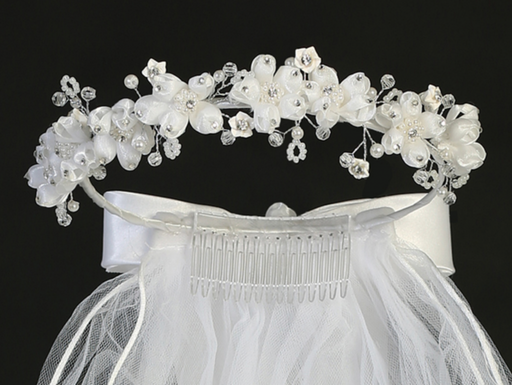 Close-up rhinestone floral details on a little girl's white sheer First Communion veil