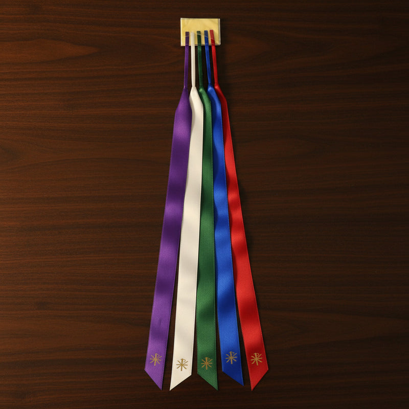 Set of colorful ribbons with decorative ends on a wooden surface