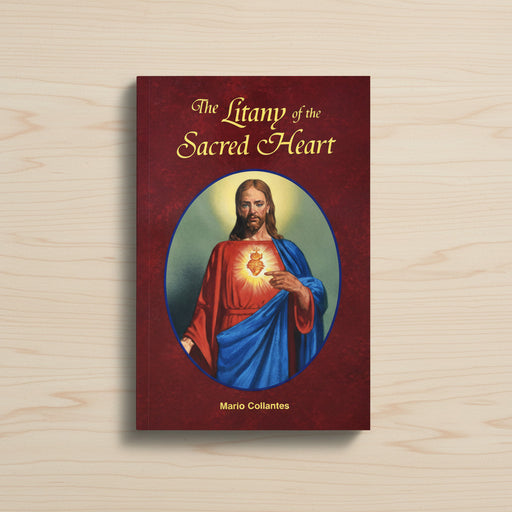 Red paperback book entitled 'The Litany of the Sacred Heart' on a light wood background.
