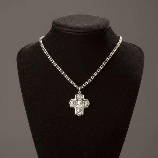 Silver chain necklace with a cross pendant on a black mannequin bust against a gray background