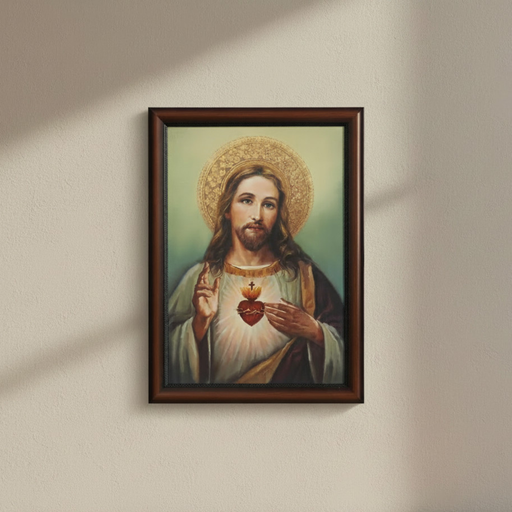Framed artwork of a religious figure holding a heart on a beige wall.
