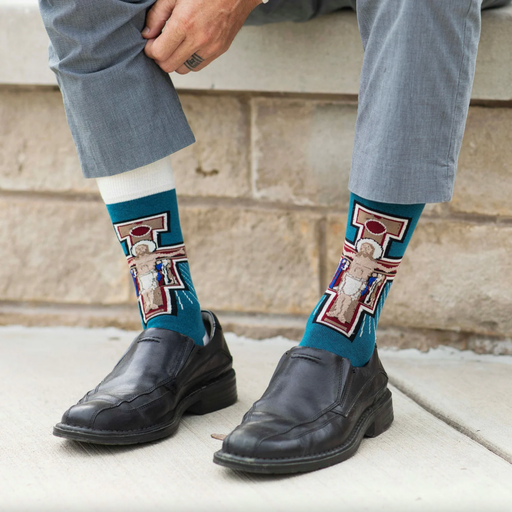 Person wear teal and white socks featuring an image of the Franciscan San Damiano crucifix