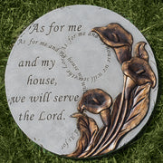 Decorative stone with floral design and engraved text on grass