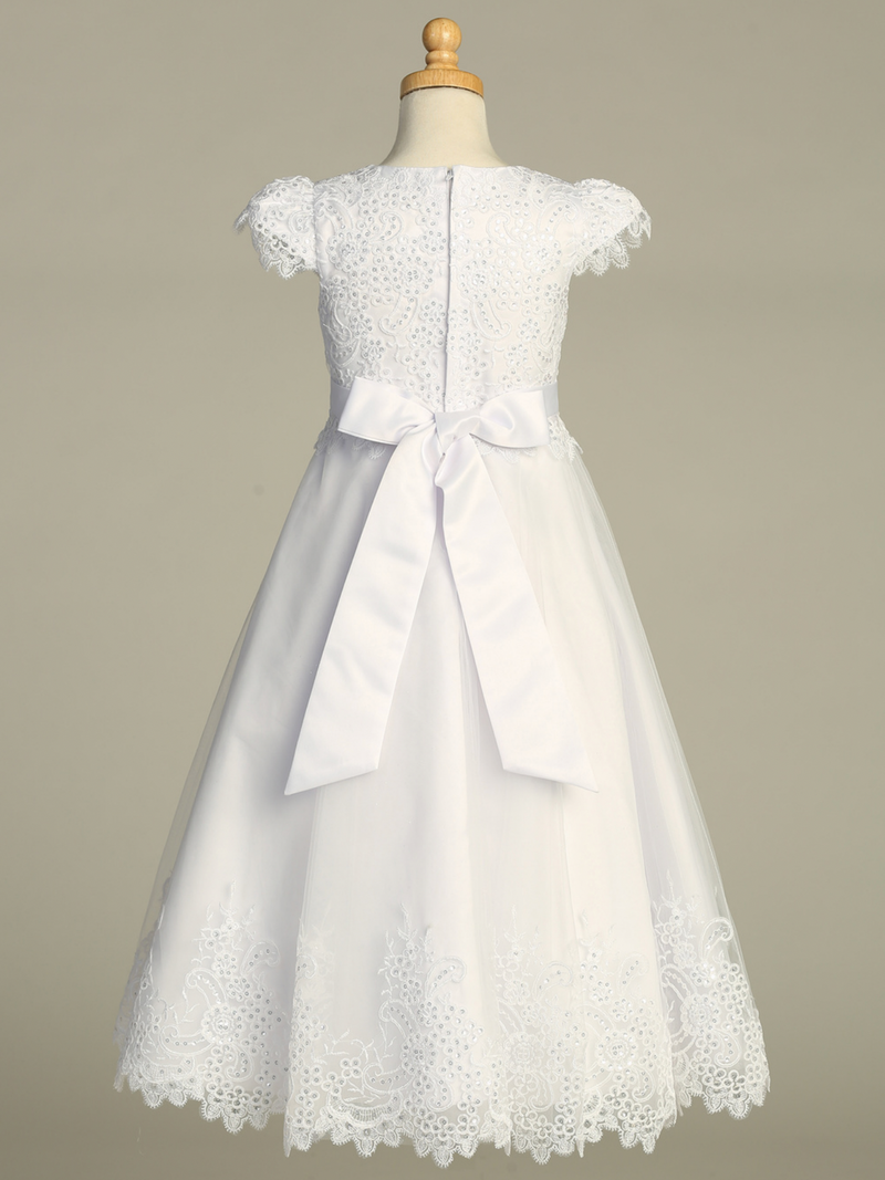 Rear shot of a white lace First Communion dress with sequins over a gray background.