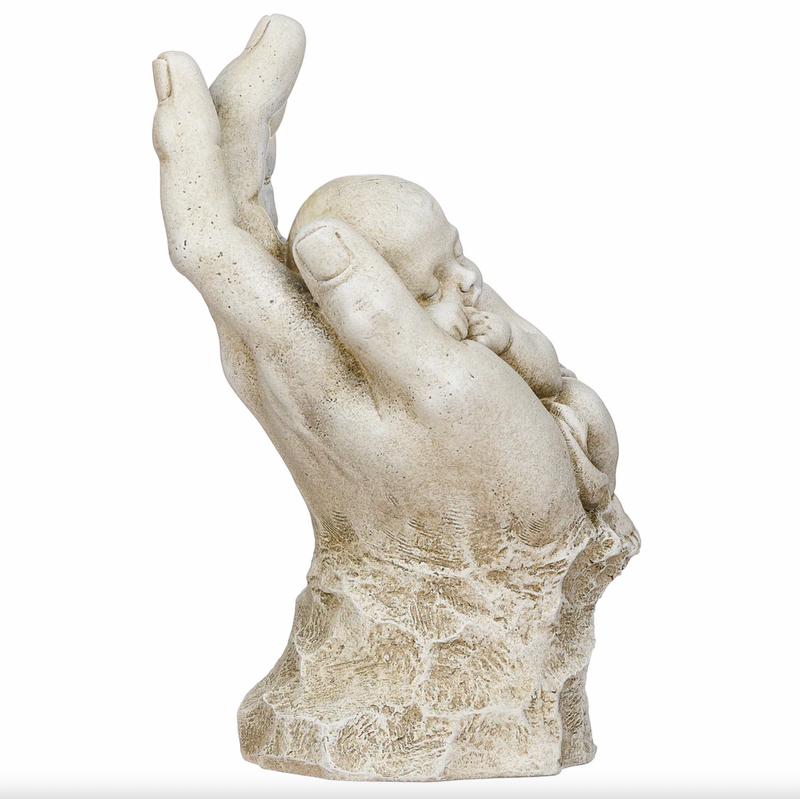 Statue of a hand holding a child on a white background