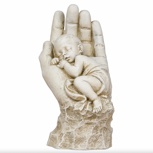 Statue of a hand holding a sleeping baby on a white background