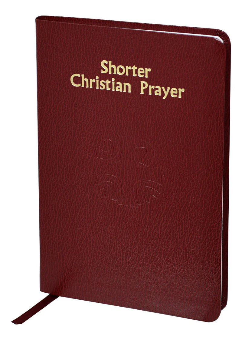 Red leather prayer book with 'Shorter Christian Prayer' text on a white background
