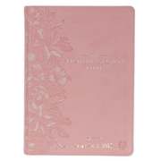 Pink Bible with floral design and text on a white background