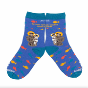 A pair of kids' socks with colorful designs and an image of St. Anthony of Padua holding the Christ Child