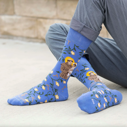 A person wearing blue crew socks featuring an image of St. Anthony of Padua holding the Infant Jesus