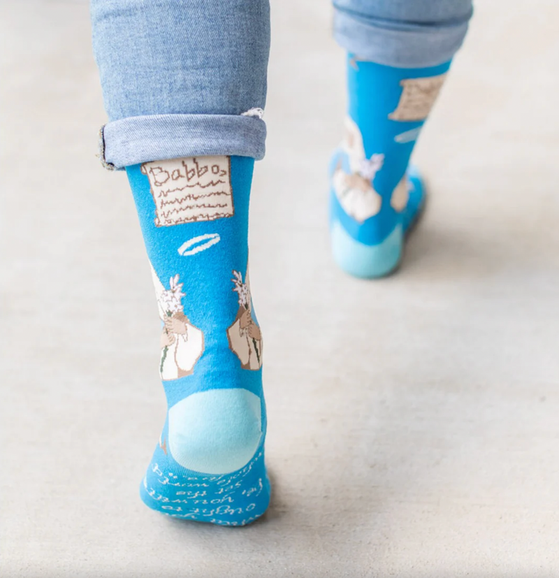 Person wearing blue socks featuring an image of St. Catherine of Siena holding a lily