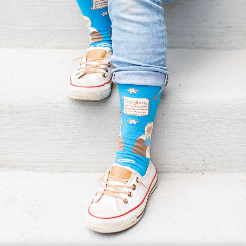 Person wearing blue socks featuring an image of St. Catherine of Siena holding a lily