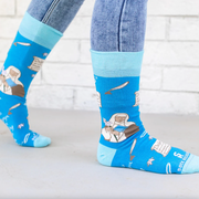 Person wearing blue socks featuring an image of St. Catherine of Siena holding a lily