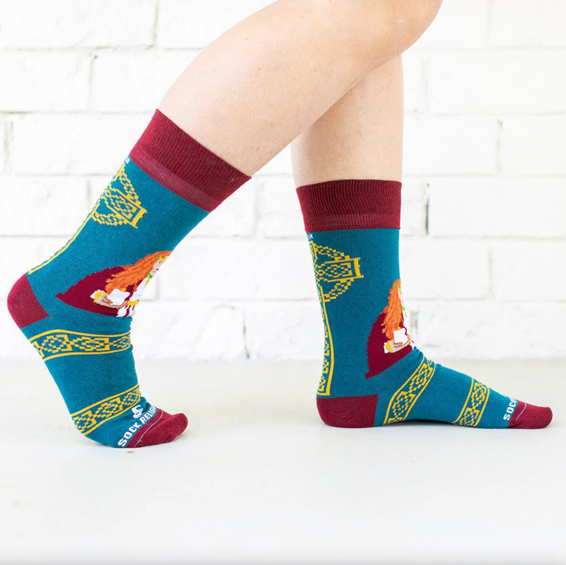 Person wearing teal and orange socks featuring an image of St. Dymphna