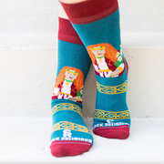 Person wearing teal and orange socks featuring an image of St. Dymphna