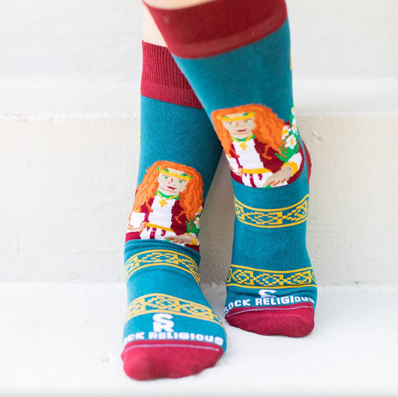 Person wearing teal and orange socks featuring an image of St. Dymphna