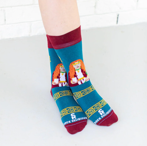 Person wearing teal and orange socks featuring an image of St. Dymphna