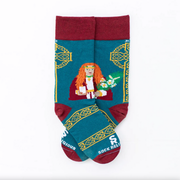 A pair of adult socks with a design featuring St. Dymphna, predominantly in shades of green and red, with Celtic cross illustrations in the background.