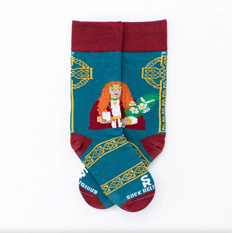 A pair of adult socks with a design featuring St. Dymphna, predominantly in shades of green and red, with Celtic cross illustrations in the background.