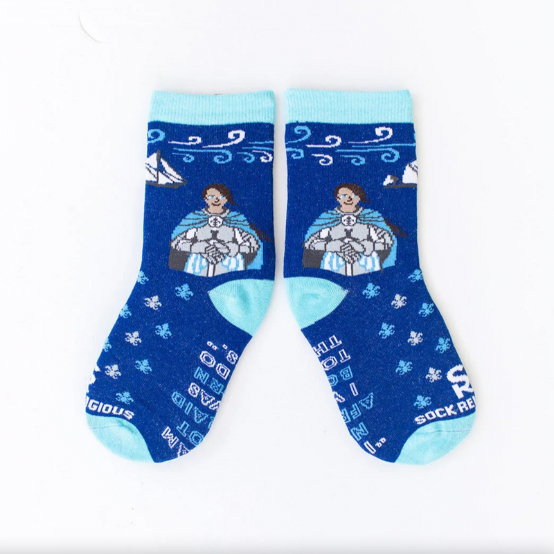 A pair of blue socks with cartoon images of St. Joan of Arc and a fleur-de-lis background, designed for kids.