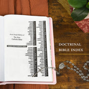 Open book with a doctrinal Bible index on a wooden surface, surrounded by a rosary and decorative items.
