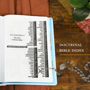 Open book with doctrinal Bible index on a wooden surface with a rosary.