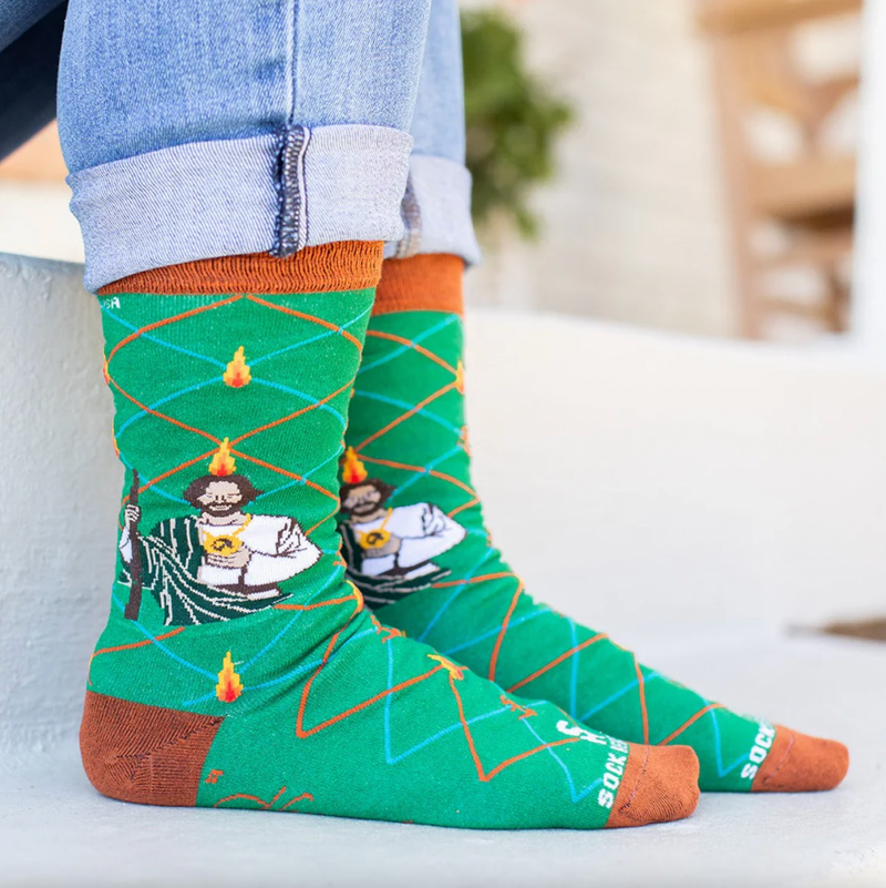Person wearing vibrant green socks with an image of St. Jude
