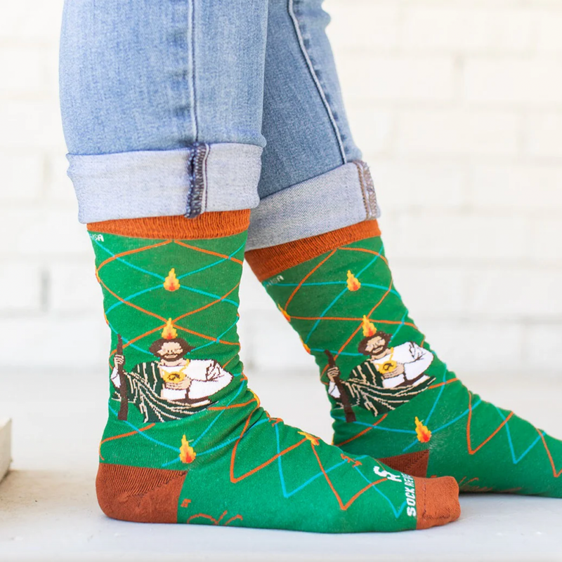 Person wearing vibrant green socks with an image of St. Jude