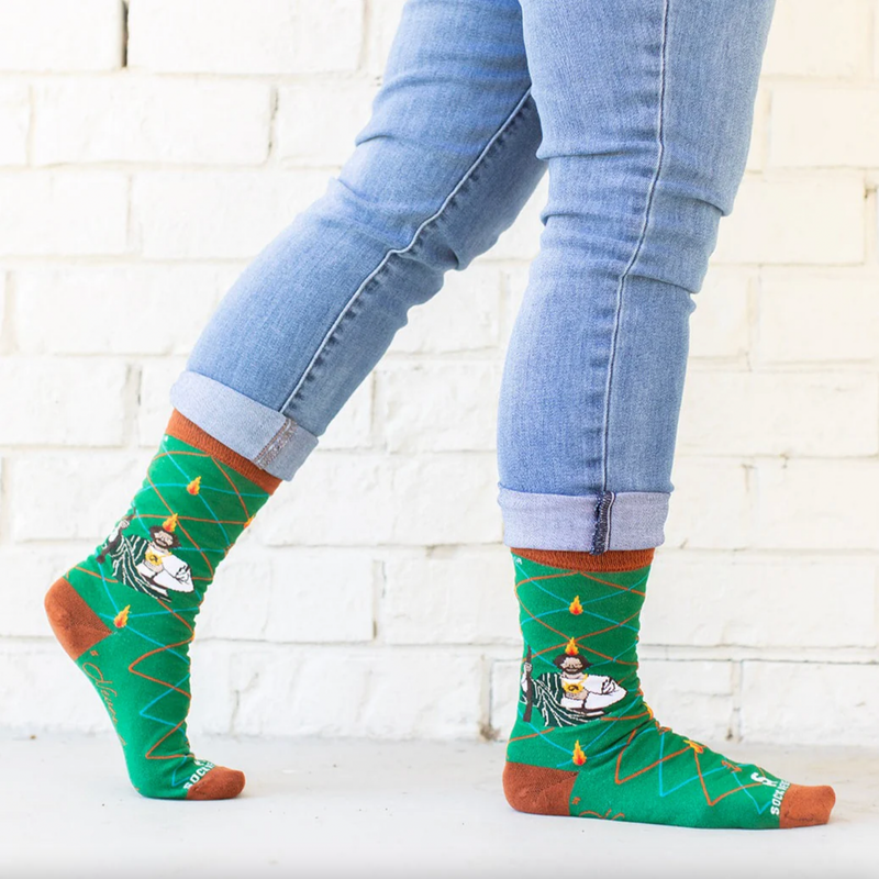 Person wearing vibrant green socks with an image of St. Jude