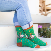 Person wearing vibrant green socks with an image of St. Jude