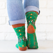 Person wearing vibrant green socks with an image of St. Jude