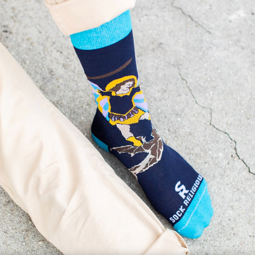 Person wearing blue socks featuring an image of St. Michael the Archangel