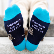 Person wearing blue socks featuring an image of St. Michael the Archangel